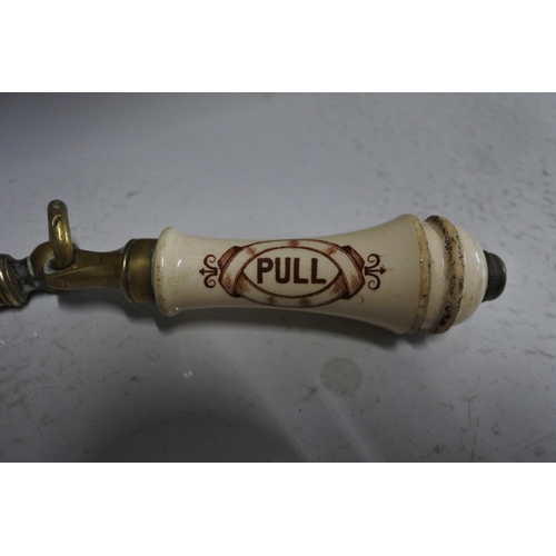 541 - An antique porcelain pull cord handle.