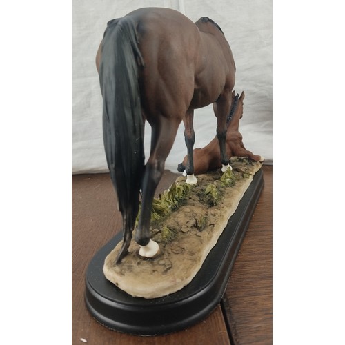 372 - A stunning ceramic horse with foal figure in original card box.