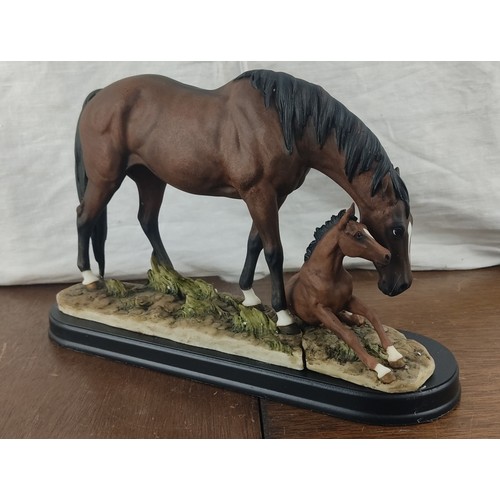 372 - A stunning ceramic horse with foal figure in original card box.