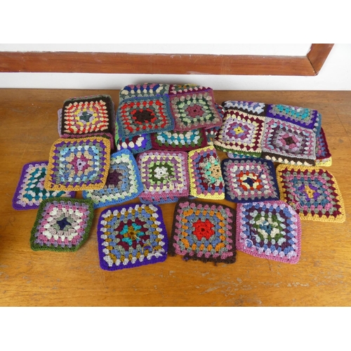 57 - An assortment of hand knitted squares.