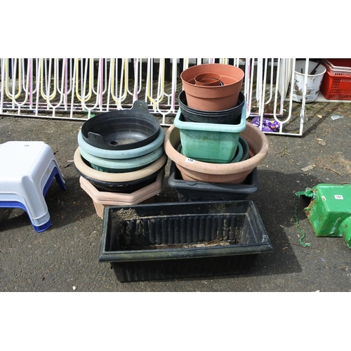 156 - A large assortment of plastic planters.