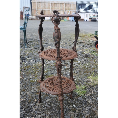 68 - An antique cast iron pot stand, measuring 64cm in height roughly.