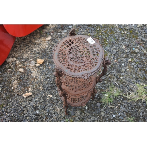 68 - An antique cast iron pot stand, measuring 64cm in height roughly.