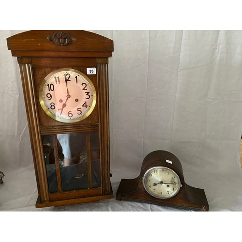 35 - A 1930's wall clock with silvered dial, in an oak case with glass door and a mantel clock in a swept... 