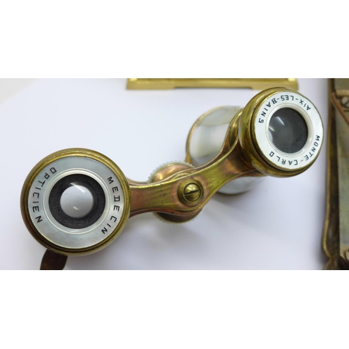 642 - A pair of French brass and mother of pearl opera glasses with handle, marked Monte-Carlo Aix-Les-Bai... 