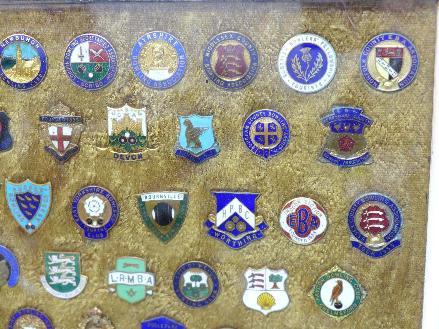 A collection of lawn bowls clubs and associations badges, framed