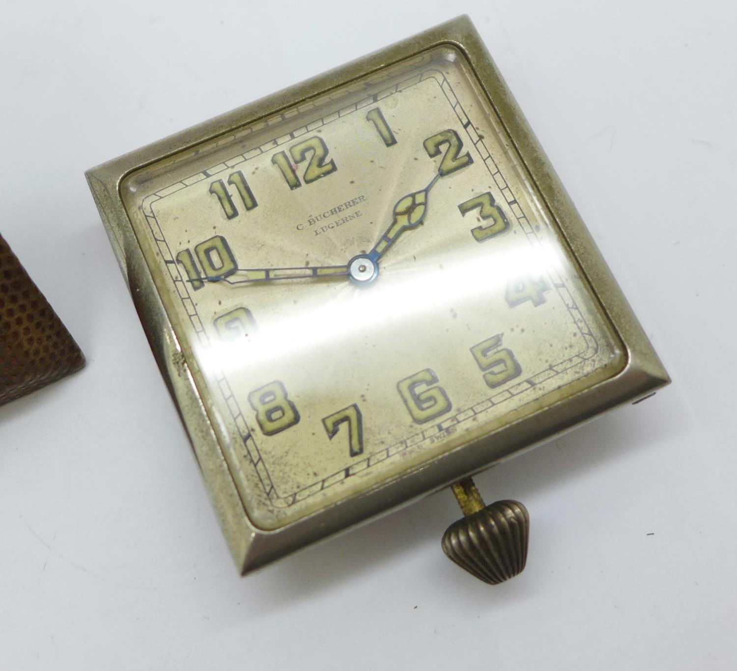 A C. Bucherer travel clock, no case, and an 8 Days travel clock