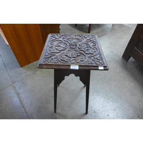 12a - An Arts and Crafts carved oak occasional table