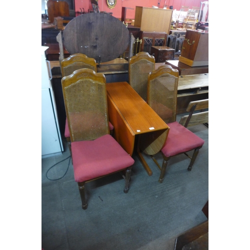 A teak dropleaf table and four bergere chairs Barnebys