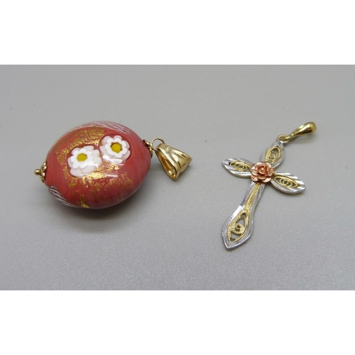 931 - A yellow metal cross pendant marked 333, 1.2g, and a 9ct gold mounted Murano glass pendant