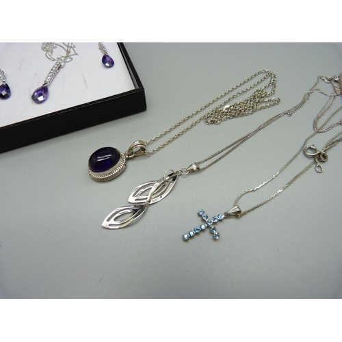 985 - A silver and amethyst pendant and three other pendants and chains