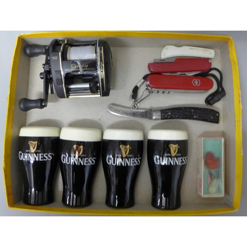 650 - Two pairs of Guinness salt and pepper pots, a fishing reel and four pocket knives
