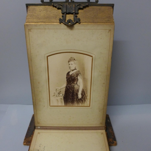 652 - An album on stand containing twenty-two Victorian cabinet cards