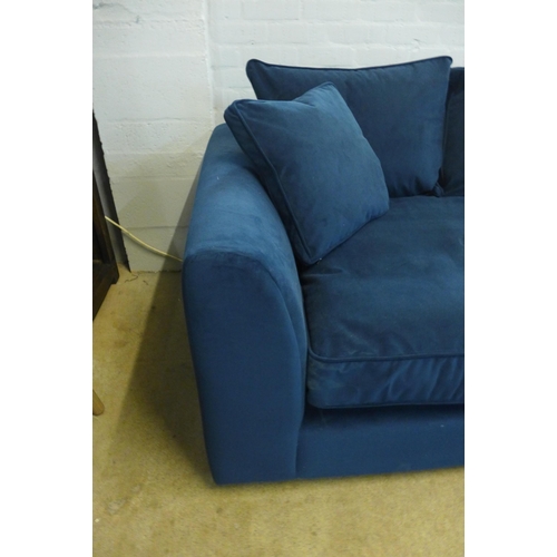 1322 - A deep ocean blue velvet upholstered three seater sofa