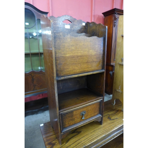 11 - An early 20th Century oak newspaper stand