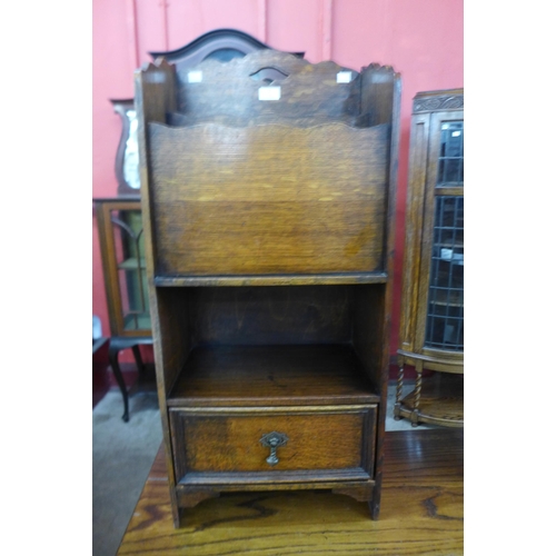 11 - An early 20th Century oak newspaper stand
