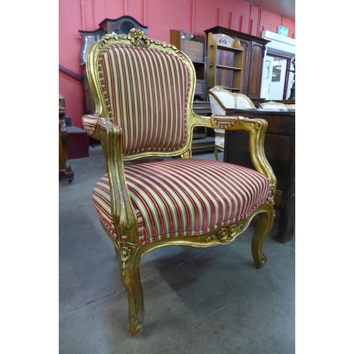 15 - A French Louis XV style giltwood and fabric upholstered fauteuil armchair