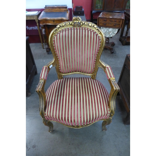 15 - A French Louis XV style giltwood and fabric upholstered fauteuil armchair