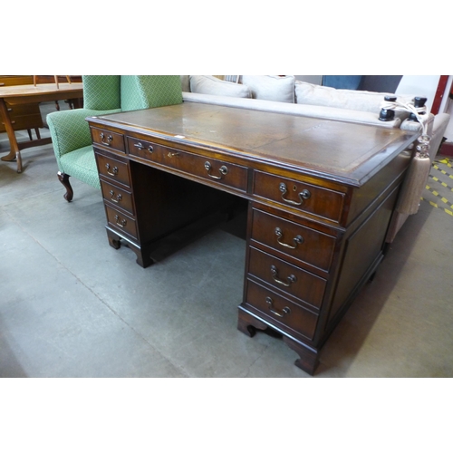 34 - A mahogany and brown leather topped library desk