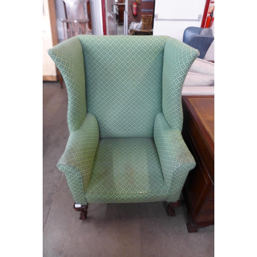35 - A Victorian mahogany and green fabric upholstered wingback armchair
