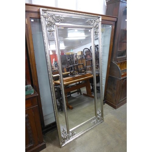 A large French style silver effect framed mirror