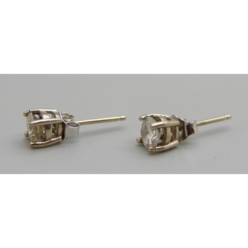 957 - A pair of 18ct gold and diamond ear studs, approximately 0.90 total carat weight