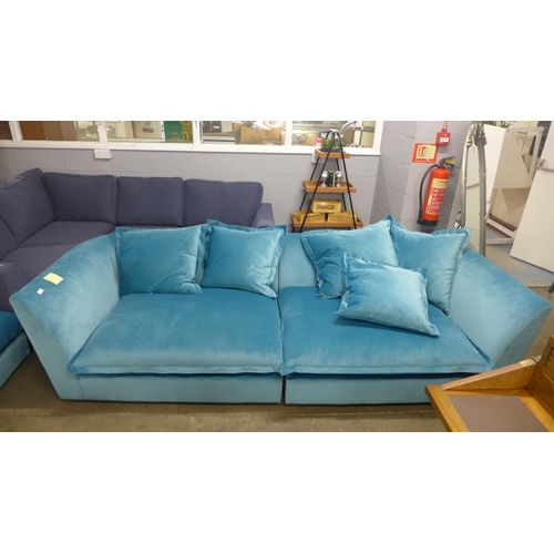 1379 - An aquamarine plush four and a half seater sofa - marked and footstol