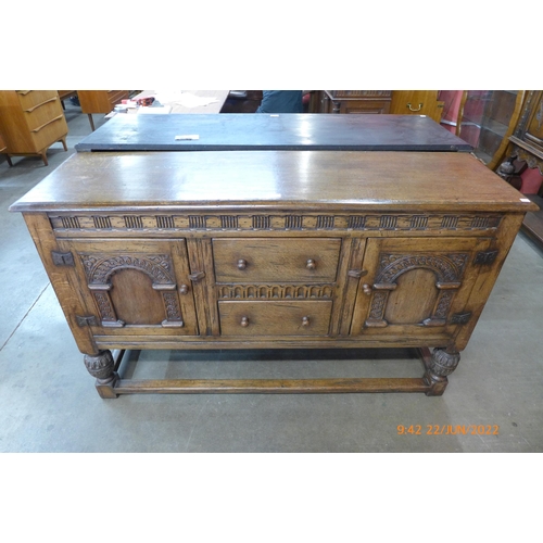 10 - An Elizabethan Revival carved oak dresser
