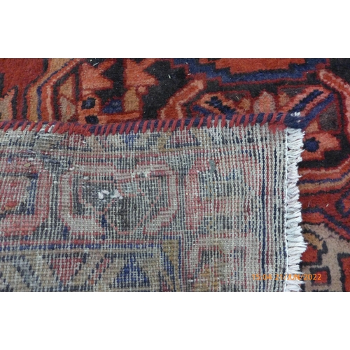 21 - A Persian red ground Herris runner rug, 427 x 115cms
