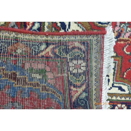 22 - A Persian red ground Tabriz rug, 393 x 303cms