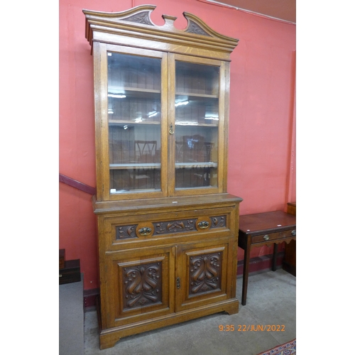 3 - A late Victorian carved oak secretaire bookcase