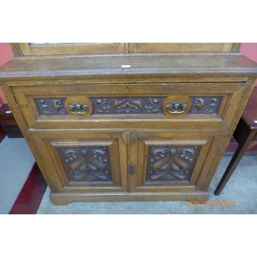 3 - A late Victorian carved oak secretaire bookcase