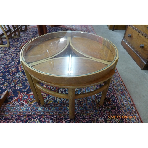 33 - A Nathan teak and glass topped circular nest of tables