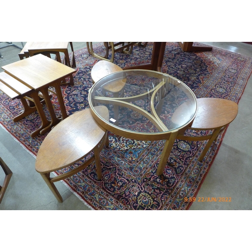 33 - A Nathan teak and glass topped circular nest of tables
