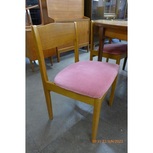 46 - A teak extending dining table and four chairs