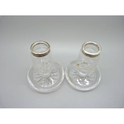 840 - A pair of silver rimmed cut glass candlesticks, 8.5cm