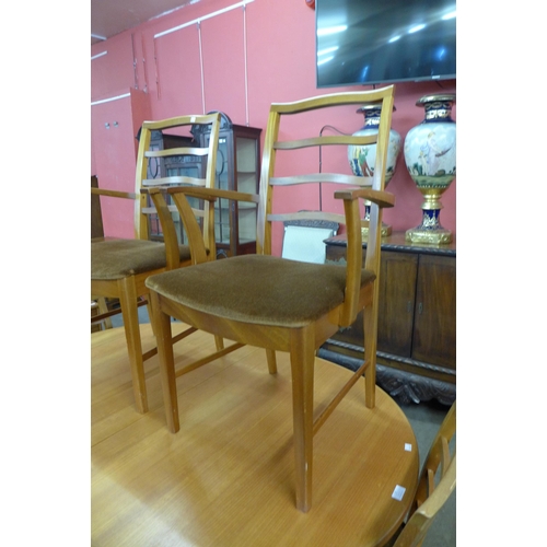 24 - A McIntosh teak extending dining table and six chairs