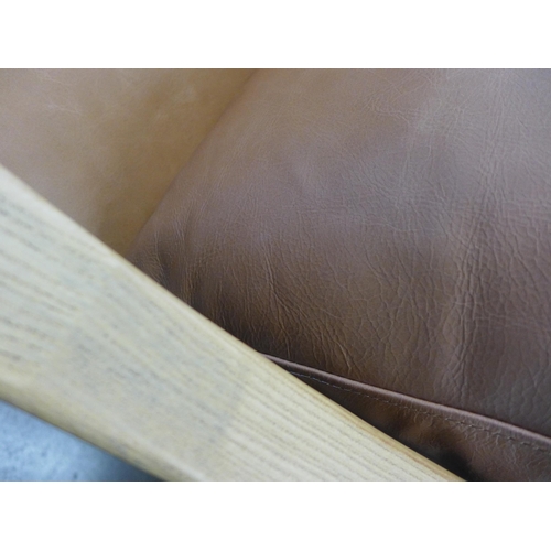1324 - An Ashford leather armchair, repaired
