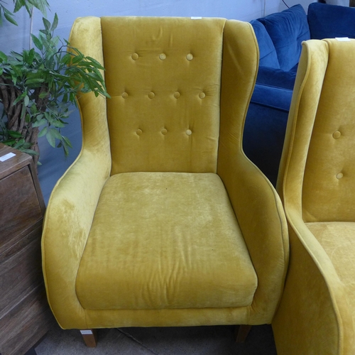 1335 - A mustard yellow button backed armchair