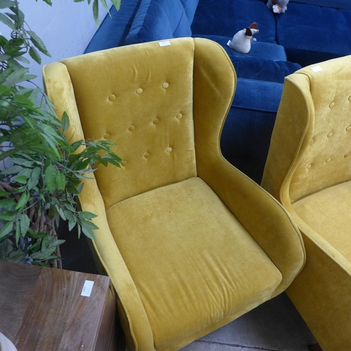 1335 - A mustard yellow button backed armchair