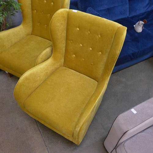 1336 - A mustard yellow button backed armchair