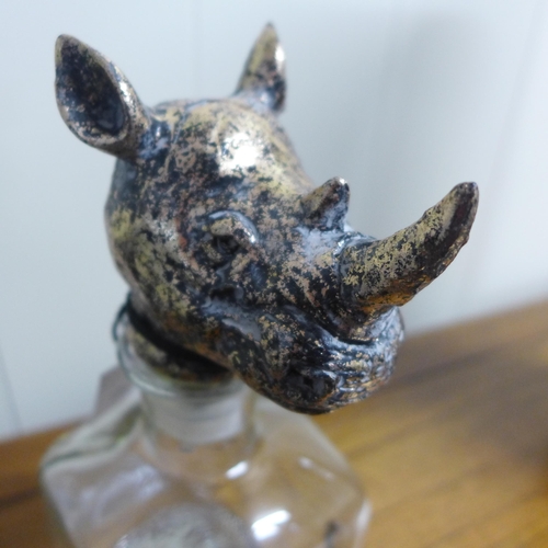 1355 - A glass storage bottle with rhino head stopper, H 24cms (HKL3506)   #