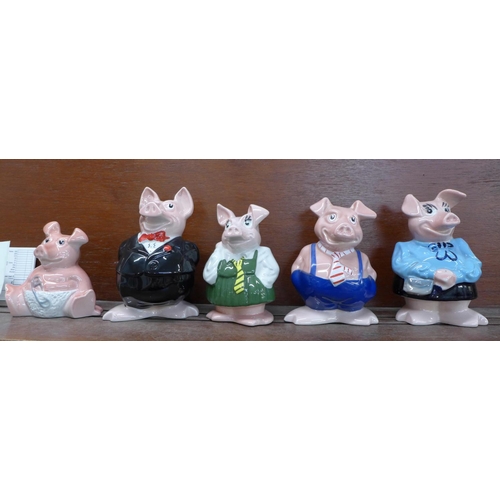 601 - A set of five Nat West pig money banks, with cheque book