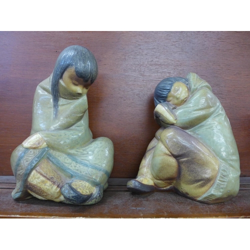 606 - A pair of Lladro figures, Eskimo boy and Eskimo girl, matt finish, tallest 29cm