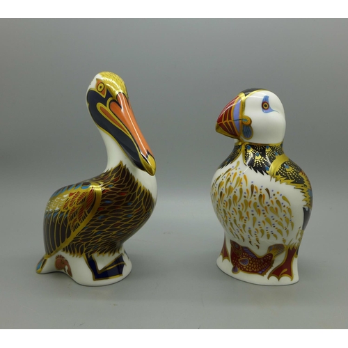 627 - Two Royal Crown Derby Sea Bird paperweights, Puffin and Brown Pelican, both 13cm high, silver stoppe... 