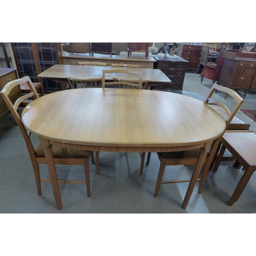 24 - A McIntosh teak extending dining table and six chairs