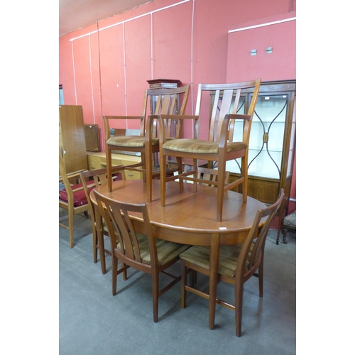 36 - A teak extending dining table and six chairs