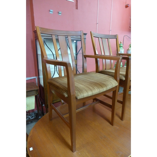 36 - A teak extending dining table and six chairs