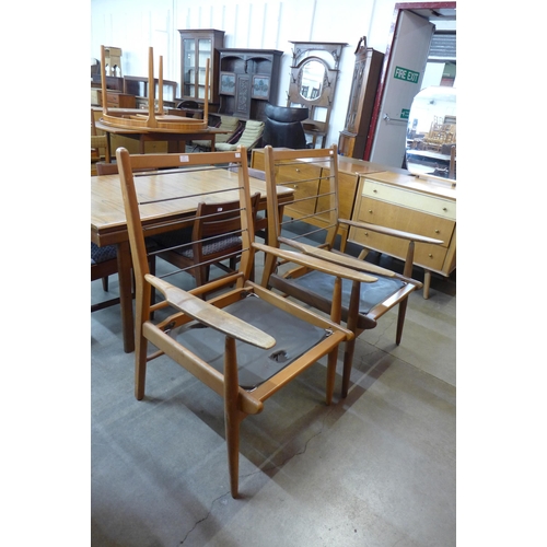 37 - A pair of Cintique teak armchairs
