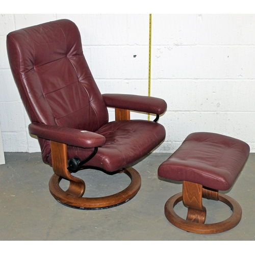 An Ekornes Stressless leather chair and footstool in Burgundy